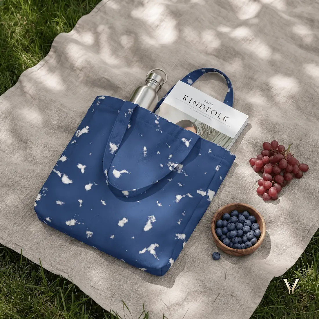 Oceanic Mist AOP Designer Large Tote Bag by VertexVault Studio in a picnic flat lay, showing the deep blue sea-foam pattern bag with a water bottle and magazine next to fresh blueberries and grapes on a blanket.