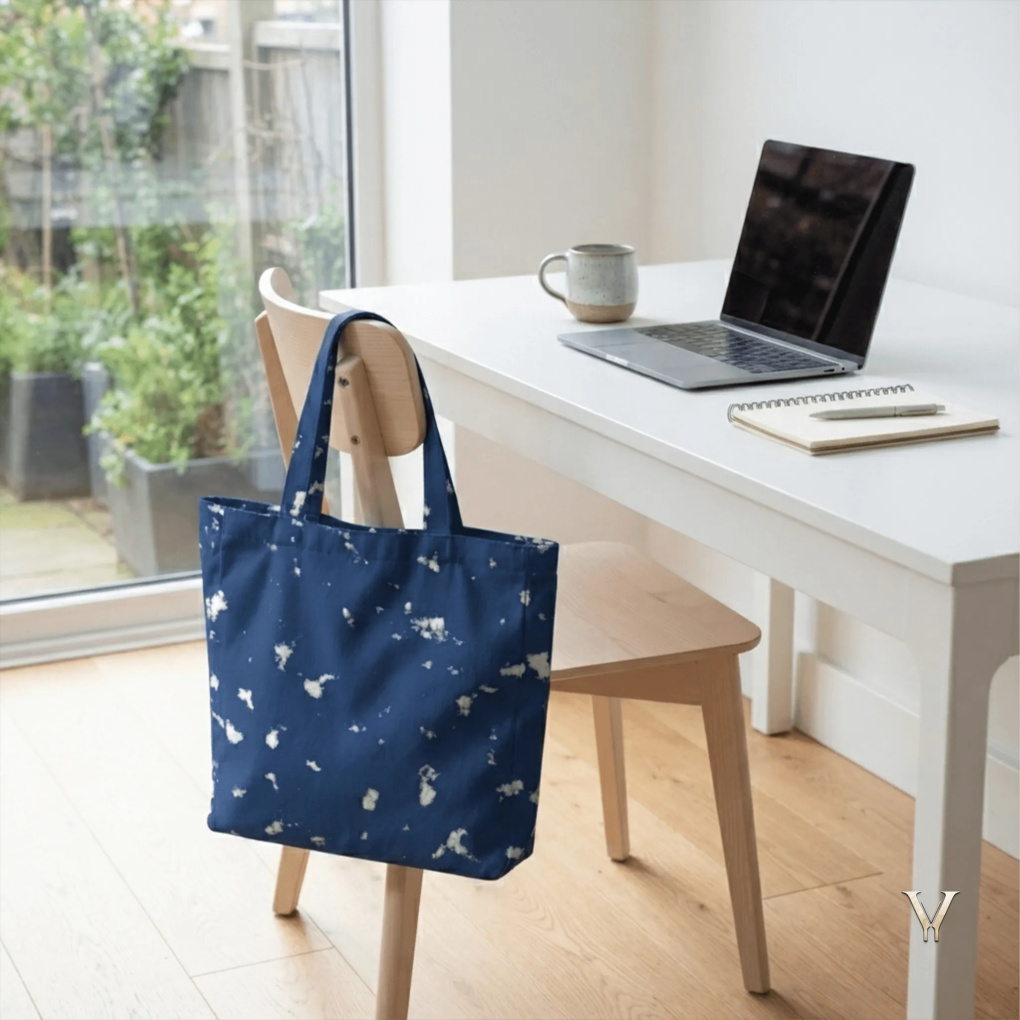 Oceanic Mist AOP Designer Large Tote Bag by VertexVault Studio hanging on an office chair next to a white desk with a laptop, notebook, and coffee mug in a bright minimalist workspace.
